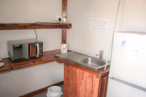a small kitchen with a sink and a refrigerator at Heydays B&B in Noupoort