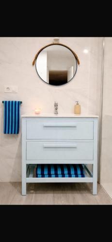 a bathroom with a white dresser and a mirror at Beachfront Studio in Castillo de la Duquesa in Castillo de Sabinillas