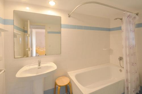 a bathroom with a sink and a tub and a mirror at Quatre vents Ref 163 in Begur
