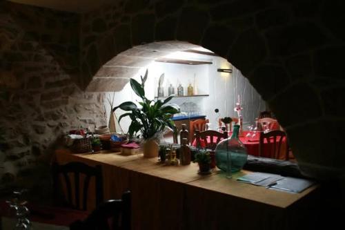 a dark room with a counter with a table with chairs at Fonda Angeleta in Valderrobres