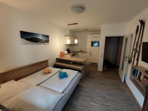 a bedroom with a bed with flip flops on it at Ferienwohnung Loitfelder-Pang in Saalbach-Hinterglemm