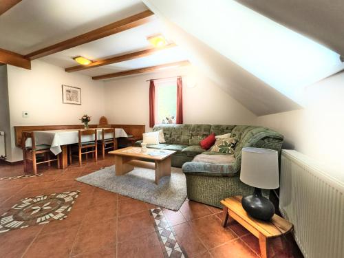a living room with a couch and a table at Apartma Brin Rogla in Zreče