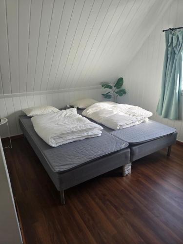 a bed with two pillows at Cabin in Leirvåg in Leirvåg