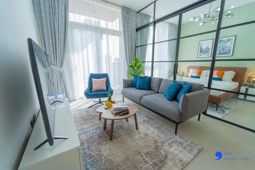 a living room with a couch and a table at AWS Holiday Homes - Stylish 2BR Apt at Dubai Hills in Dubai
