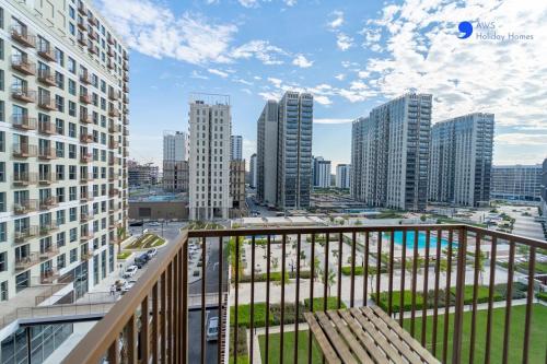 a balcony with a view of a city with tall buildings at AWS Holiday Homes - Stylish 2BR Apt at Dubai Hills in Dubai