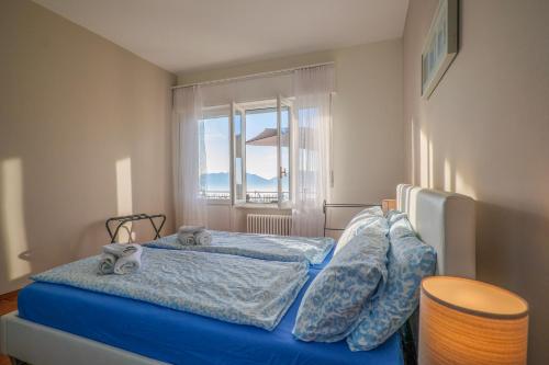 a bedroom with two beds and a window at Al Pianaccio by Lago Reisen in Trarego Viggiona