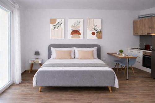 a bedroom with a large bed and a kitchen at Le Suite del Pastore, Monolocale con Terrazza Privata e Parcheggio Facile, vicino al Centro in Lecce