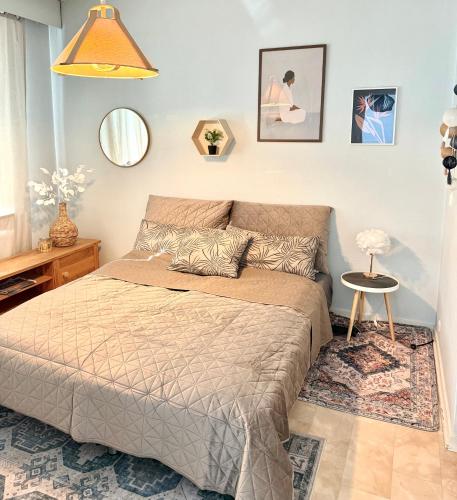 a bedroom with a bed and a table and a mirror at Midnight Sun center apartments in Sodankylä