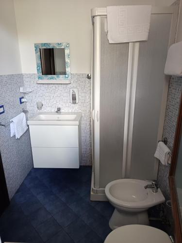 a bathroom with a white sink and a toilet at A due passi dal mare in Capo dʼOrlando