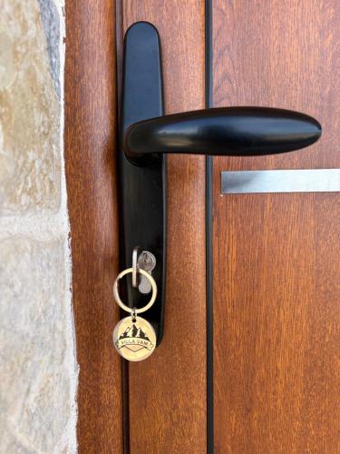 a doorhandle with a key on a wooden door at Zabljak villa VAM in Žabljak