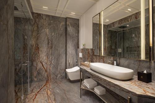 a bathroom with a sink and a shower at Angsana Oasis Spa & Resort in Yelahanka