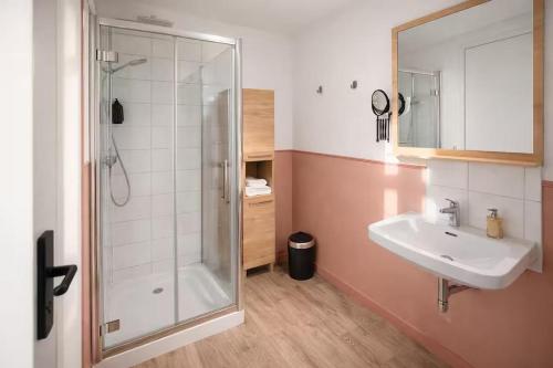 a bathroom with a shower and a sink at Flor du Mont Gîte in Pontorson