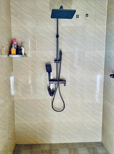 a shower with a blow dryer on a wall at Ewafe Safari Lodge-Murchison in Wanseko
