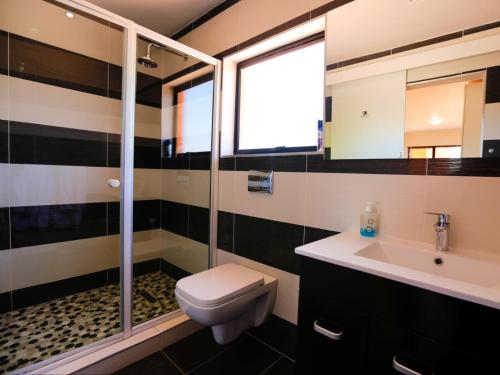 a black and white bathroom with a toilet and a sink at Grand View B&B in Johannesburg