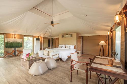 a bedroom with a bed and a table at The Vineyard Hideaway Khaoyai in Ban Wang Phaem