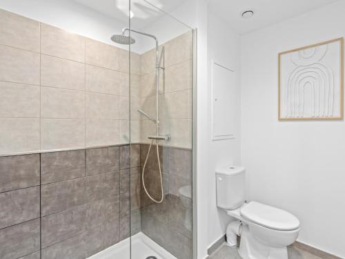 a bathroom with a shower and a toilet at Ocean Breeze, Fully Renovated Beachfront 2 bdr in Baie Nettle