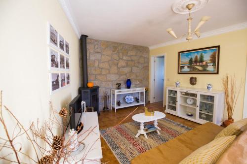 a living room with a couch and a table at Cabanelas Country House - Casa do Afonso in Vale de Cambra