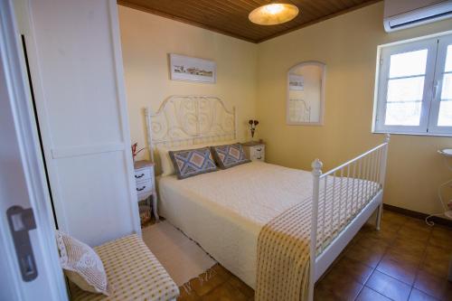 a small bedroom with a bed and a window at Cabanelas Country House - Casa do Afonso in Vale de Cambra