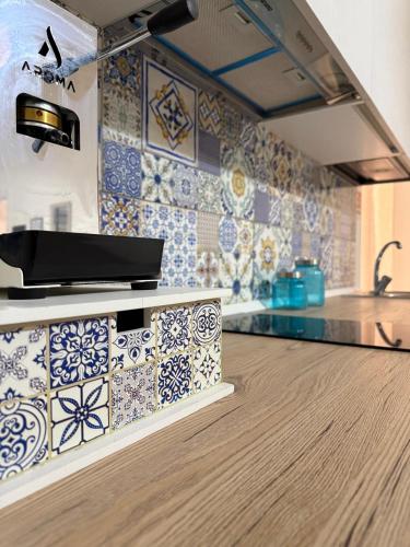 a kitchen with blue and white tiles on the wall at Emme9 in Gaeta