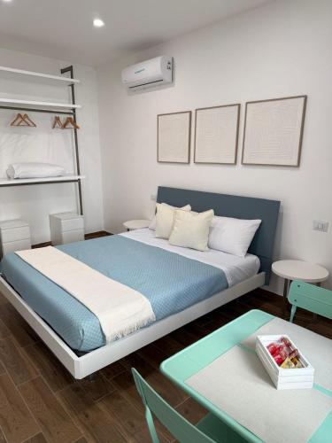 a bedroom with a bed and a table at Emme9 in Gaeta