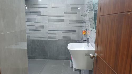 a bathroom with a toilet and a sink and a shower at Hotel Tamilnadu Trichy in Tiruchirappalli