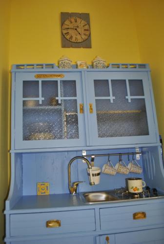 a toy kitchen with a sink and a clock at Apartment Pod Kostanji in Osp