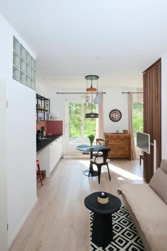 a living room with a couch and a table at AuxMoulins in Neuchâtel