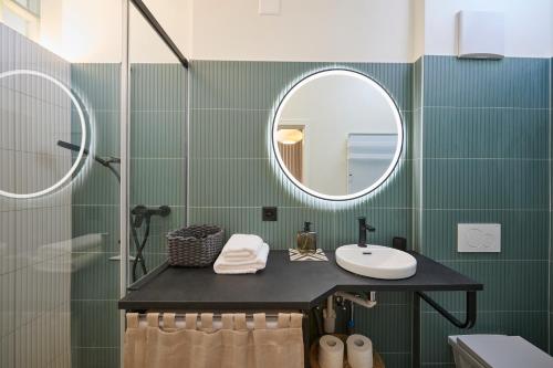 a bathroom with a sink and a mirror at AuxMoulins in Neuchâtel