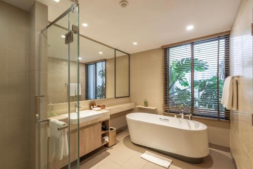 a bathroom with a tub and a sink and a shower at The Vineyard Hideaway Khaoyai in Ban Wang Phaem