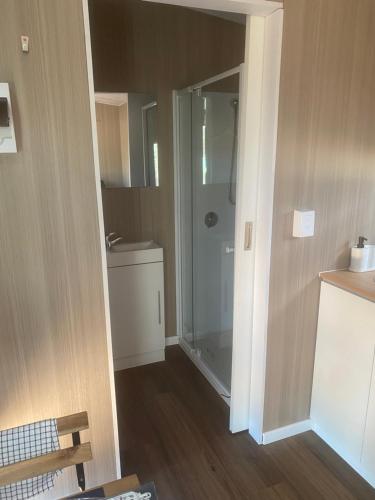a small bathroom with a shower and a toilet at plain Bush in Bohena Creek