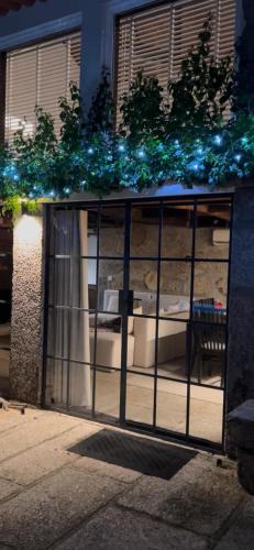 a glass door with blue lights in a building at Casa de Rompecias in Vizela