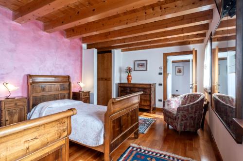 a bedroom with a bed and two chairs in a room at B&B Il Pettirosso in Negrar
