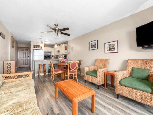 a living room with a couch and chairs and a table at Banyan Harbor Resort in Lihue