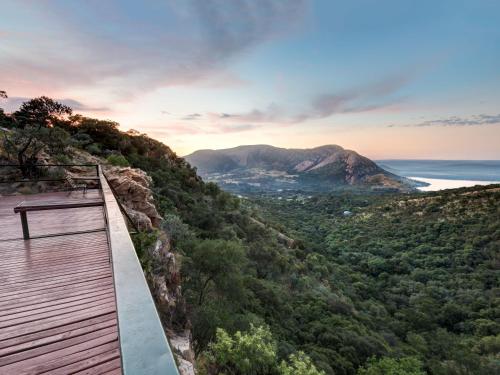 a wooden boardwalk on a mountain overlooking the ocean at ANEW Resort Hunters Rest Rustenburg in Rustenburg