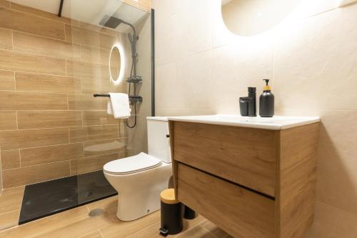 a bathroom with a white toilet and a sink at DouroParadise Apartment in Peso da Régua