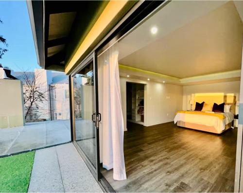 a bedroom with a bed and a sliding glass door at 3066 Water Edge in Parys