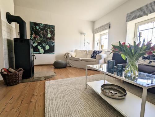 a living room with a couch and a fireplace at Ferienhaus Swanen Hus in Nordstrand