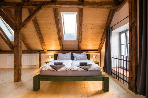 a bedroom with a bed in a room with wooden ceilings at Ubytování V Klenbách in Třeboň