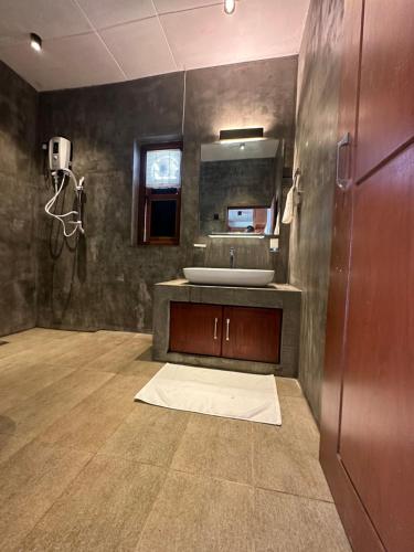 a bathroom with a sink and a mirror at SAHAS Villa - Private Riverfront Garden Retreat in Beruwala in Beruwala