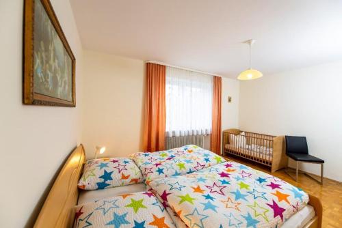 a bedroom with a bed and a crib at Haus Heidi mit Balkon in Moosbach