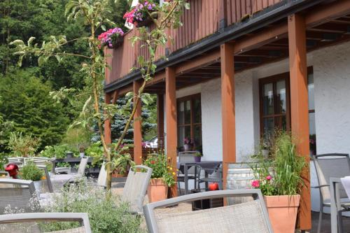 a group of chairs sitting outside of a building at Hotelchen Schönblick in Gößweinstein
