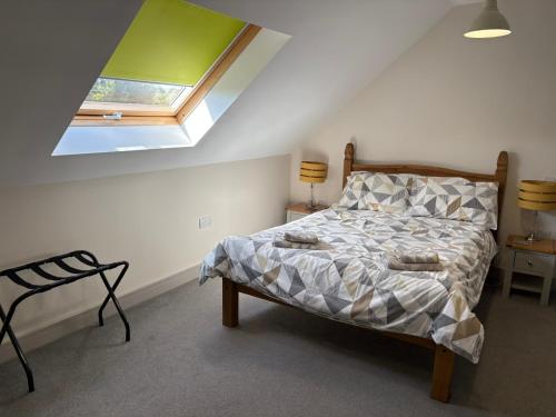 a bedroom with a bed and a skylight at Bike Shed 1-Bed Cottage Sleeps 2 Pet Friendly in Shorwell