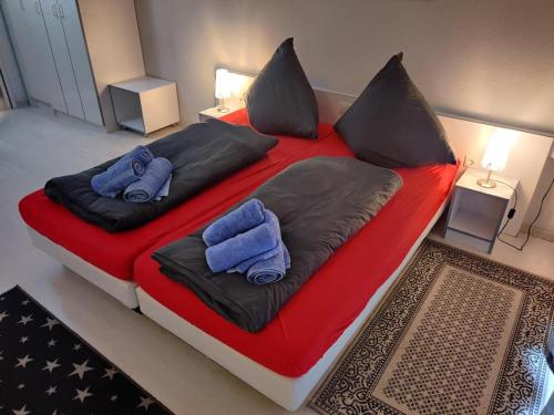 a large bed with two blue pillows on it at "Tossens Ahoi" in Tossenserdeich