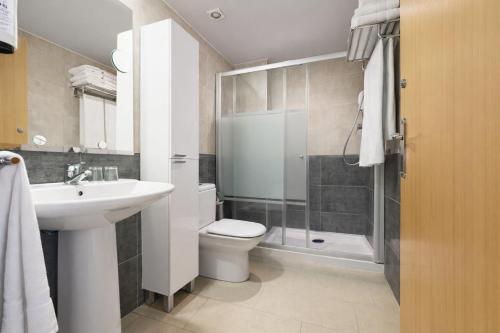 a bathroom with a toilet and a sink and a shower at Neptuno Aparthotel in Calella