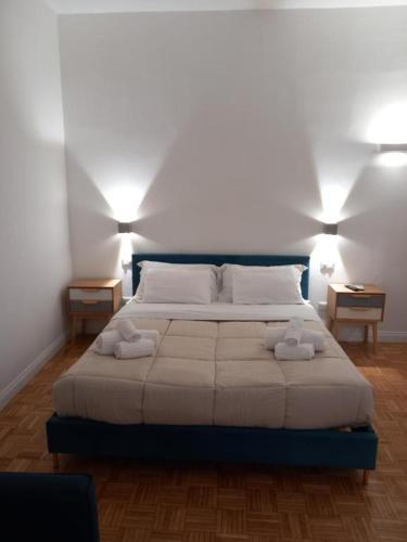 a bedroom with a bed with two towels on it at La Dolce Vita in Naples