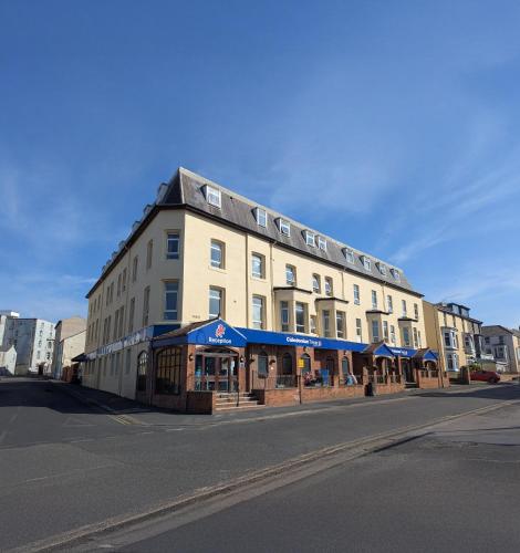 a large building on the side of a street at The Caledonian Tower Hotel in Blackpool