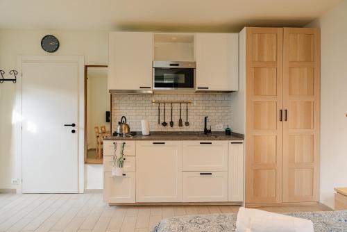 a kitchen with white cabinets and a counter top at Casa Galya with private patio by GardaDoma in Brenzone sul Garda