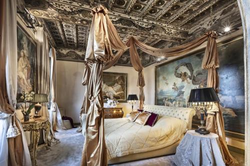 a bedroom with a canopy bed and paintings on the ceilings at Domus 3 Badroom Piazza Venezia in Rome