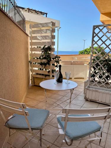 a patio with a table and chairs on a balcony at Arcobaleno Tropea centro in Tropea