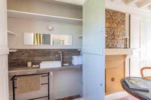 a bathroom with a sink and a mirror at Clos Chartrain in La Chartre-sur-le-Loir